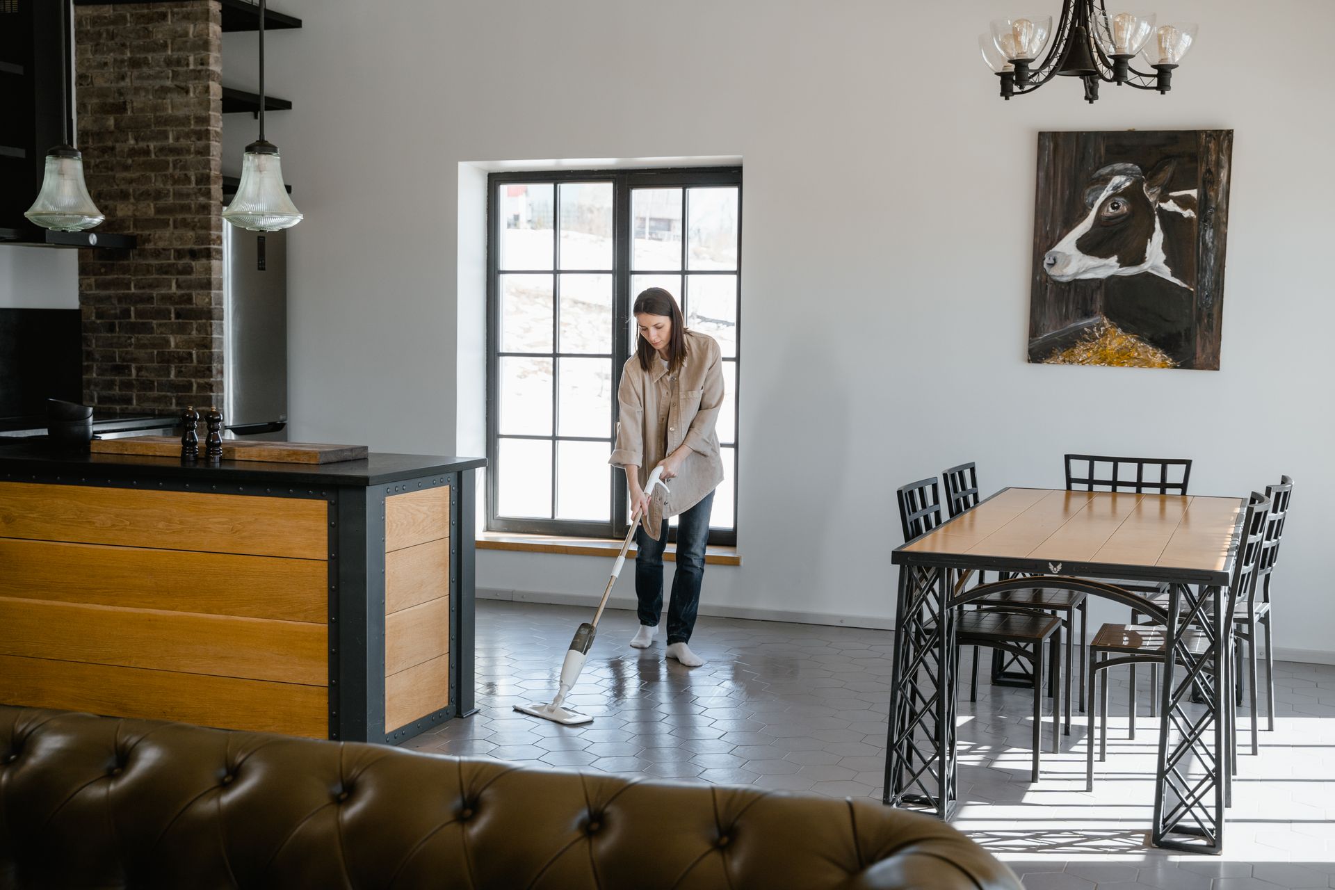 Cleaner working in a bright home